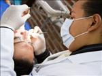 Dr. Giancarlo Medina with a Patient - Cancun Cosmetic Dentistry